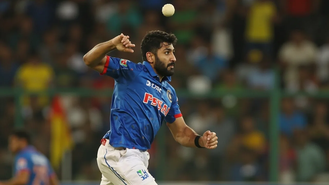 Tight sideline action frame of a fast bowler at the end of his follow-through, shallow depth of field, ball just released